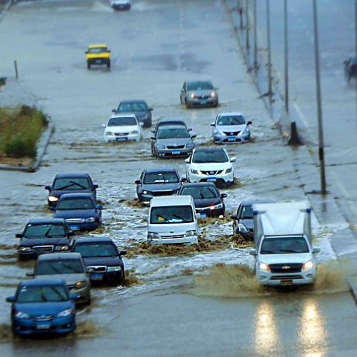 Cars on flooded road VICTVS Global Network